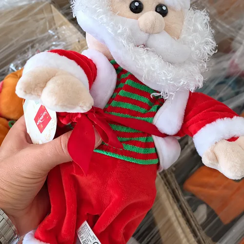 Lot of dancing stuffed Santa Clauses